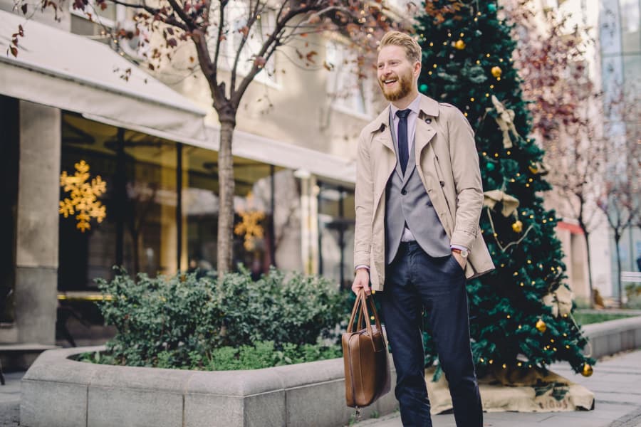 Stylish businessman walking in winter attire during holiday season